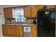 Kitchen features wooden cabinets, a stainless steel sink, and modern appliances at 520 Dixson St, Orange City, FL 32763