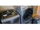 The laundry room features modern, stainless steel washer and dryer units at 520 Dixson St, Orange City, FL 32763
