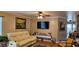 Comfortable living room features a beige leather sofa, dark-colored area rug, and a wall-mounted TV at 520 Dixson St, Orange City, FL 32763