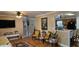 Open-concept living room with view of the kitchen, hardwood floors, ceiling fan, and bright, natural light at 520 Dixson St, Orange City, FL 32763