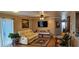 Inviting living room with a beige leather sofa, ceiling fan, decorative plants and hardwood floors at 520 Dixson St, Orange City, FL 32763