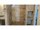 Newly renovated shower with custom tile work, rainfall shower head and built-in toiletry niche at 520 Dixson St, Orange City, FL 32763
