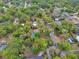 View of a wooded neighborhood with established landscaping, mature trees, and private pools at 525 E Wisconsin Ave, Orange City, FL 32763