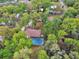 Aerial shot of a backyard with screened in pool, privacy, and mature tree growth at 525 E Wisconsin Ave, Orange City, FL 32763