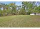 A sprawling, green backyard offers ample space for recreation, gardening, and enjoying the outdoors at 525 E Wisconsin Ave, Orange City, FL 32763
