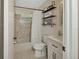 Bathroom featuring a shower/tub combo, white vanity, and decorative shelving at 525 E Wisconsin Ave, Orange City, FL 32763