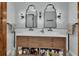 Modern bathroom featuring double vanity with decorative mirrors and updated lighting at 525 E Wisconsin Ave, Orange City, FL 32763
