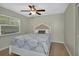 Cozy bedroom with a ceiling fan, window, and neutral decor, perfect for relaxation at 525 E Wisconsin Ave, Orange City, FL 32763