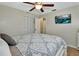 Comfortable bedroom with ample closet space, a ceiling fan, and neutral wall color scheme at 525 E Wisconsin Ave, Orange City, FL 32763