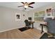 Functional bedroom with a desk setup, natural light from a window, and modern decor at 525 E Wisconsin Ave, Orange City, FL 32763