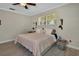 Neutral bedroom with wood-look floors, overhead fan and side tables with sconces at 525 E Wisconsin Ave, Orange City, FL 32763