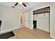 Bright bedroom with closet and doorway views, featuring wood-look flooring and a ceiling fan at 525 E Wisconsin Ave, Orange City, FL 32763