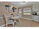 Charming breakfast nook with light wood floors, and a decorative painting of a cow at 525 E Wisconsin Ave, Orange City, FL 32763