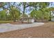 Charming single-story home with a circular driveway and mature trees enhancing its curb appeal and natural setting at 525 E Wisconsin Ave, Orange City, FL 32763