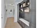 Welcoming hallway featuring built-in storage, a bench, and neutral tile flooring at 525 E Wisconsin Ave, Orange City, FL 32763