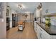 Spacious kitchen featuring white cabinets, modern lighting, and stainless steel appliances at 525 E Wisconsin Ave, Orange City, FL 32763