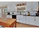 Bright kitchen with white cabinetry, dark countertops, and stainless steel accents at 525 E Wisconsin Ave, Orange City, FL 32763