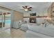 Cozy living room with fireplace, ceiling fan, and sliding glass doors to pool at 525 E Wisconsin Ave, Orange City, FL 32763
