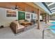 Covered patio with outdoor seating, ceiling fans, and poolside views for relaxation at 525 E Wisconsin Ave, Orange City, FL 32763