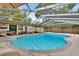 A screened-in pool featuring a spacious deck area perfect for outdoor relaxation and poolside enjoyment at 525 E Wisconsin Ave, Orange City, FL 32763