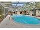 A screened-in swimming pool offers a refreshing escape with ample deck space for lounging and outdoor furniture at 525 E Wisconsin Ave, Orange City, FL 32763