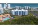 Stunning aerial view of the condo complex, nearby pool, lush greenery, and the beautiful Atlantic Ocean at 5300 S Atlantic Ave # 17-303, New Smyrna Beach, FL 32169