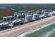 Beautiful beachfront aerial showing condos, sandy beach, and location indicator, near wetlands at 5300 S Atlantic Ave # 17-303, New Smyrna Beach, FL 32169