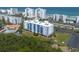Scenic aerial view of the condo, green spaces, beachfront parking, and the Atlantic Ocean backdrop at 5300 S Atlantic Ave # 17-303, New Smyrna Beach, FL 32169