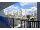 Stunning balcony view overlooking a tropical palm tree lined street and other condo buildings at 5300 S Atlantic Ave # 17-303, New Smyrna Beach, FL 32169