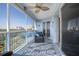 Screened-in porch with comfortable seating, ceiling fan, and beautiful views at 5300 S Atlantic Ave # 17-303, New Smyrna Beach, FL 32169