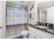 Bathroom featuring neutral tones with shower-tub combination and decorative shower curtain at 5300 S Atlantic Ave # 17-303, New Smyrna Beach, FL 32169
