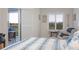 Comfortable bedroom featuring sliding glass doors leading to an outdoor balcony sitting area at 5300 S Atlantic Ave # 17-303, New Smyrna Beach, FL 32169