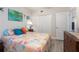 Bedroom featuring seashell bedding, nautical decor, and adjacent closet and entry door at 5300 S Atlantic Ave # 17-303, New Smyrna Beach, FL 32169