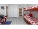 Spacious bedroom with bunkbeds featuring adjacent bathroom and ample closet space at 5300 S Atlantic Ave # 17-303, New Smyrna Beach, FL 32169