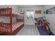 Bedroom with bunkbeds, colorful nautical decor, and bike for children at 5300 S Atlantic Ave # 17-303, New Smyrna Beach, FL 32169