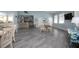 Community room with gray tile floors, seating areas, and kitchenette at 5300 S Atlantic Ave # 17-303, New Smyrna Beach, FL 32169