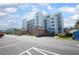 Condo exterior with covered parking and blue balconies offers a fantastic ocean view at 5300 S Atlantic Ave # 17-303, New Smyrna Beach, FL 32169