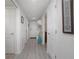 Inviting hallway with light wood floors leads to front door and other rooms at 5300 S Atlantic Ave # 17-303, New Smyrna Beach, FL 32169