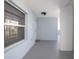 Light blue condo hallway with neutral flooring and a large window offering ample natural light at 5300 S Atlantic Ave # 17-303, New Smyrna Beach, FL 32169