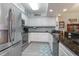 Well-lit kitchen features stainless appliances, white cabinetry, and granite countertops at 5300 S Atlantic Ave # 17-303, New Smyrna Beach, FL 32169