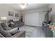 Comfortable living room with comfortable furniture and tv with sliding shuttered door at 5300 S Atlantic Ave # 17-303, New Smyrna Beach, FL 32169