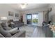 Cozy living room with sliding glass doors to the outdoor balcony with a view at 5300 S Atlantic Ave # 17-303, New Smyrna Beach, FL 32169