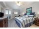 Serene bedroom with seaside themed decor, doors to balcony with a view at 5300 S Atlantic Ave # 17-303, New Smyrna Beach, FL 32169