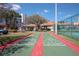 Outdoor shuffleboard court with palm trees and the clubhouse in the background at 5300 S Atlantic Ave # 17-303, New Smyrna Beach, FL 32169
