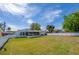 Expansive backyard with well-kept lawn, privacy fence, and view of the home's screened-in porch at 538 Gertrude Ln, South Daytona, FL 32119
