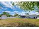 Large backyard with ample green space, enclosed by a white fence, and adjacent to the home's screened lanai at 538 Gertrude Ln, South Daytona, FL 32119