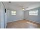 Bright bedroom features tiled floors, neutral paint, a ceiling fan, and ample natural light at 538 Gertrude Ln, South Daytona, FL 32119