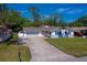 Nice view of the one-story home with a long driveway, large yard, and nice landscaping at 538 Gertrude Ln, South Daytona, FL 32119