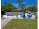 Charming single-story home with blue shutters and a well-manicured lawn, complemented by mature trees at 538 Gertrude Ln, South Daytona, FL 32119