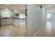 Bright kitchen with white cabinets, granite countertops, and a view into the Florida room at 538 Gertrude Ln, South Daytona, FL 32119